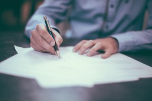 A man writing out an estate planning document